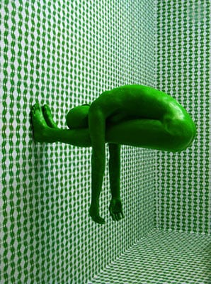 Green man stuck on green wall
