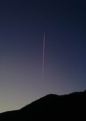 Rocket headed for space at a great distance in night sky