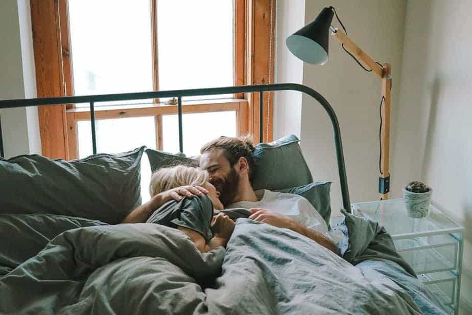 Couple cuddling in bed