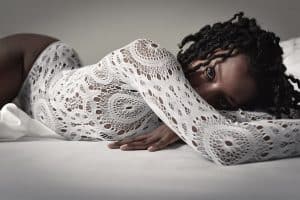Boudoir bed pose on stomach