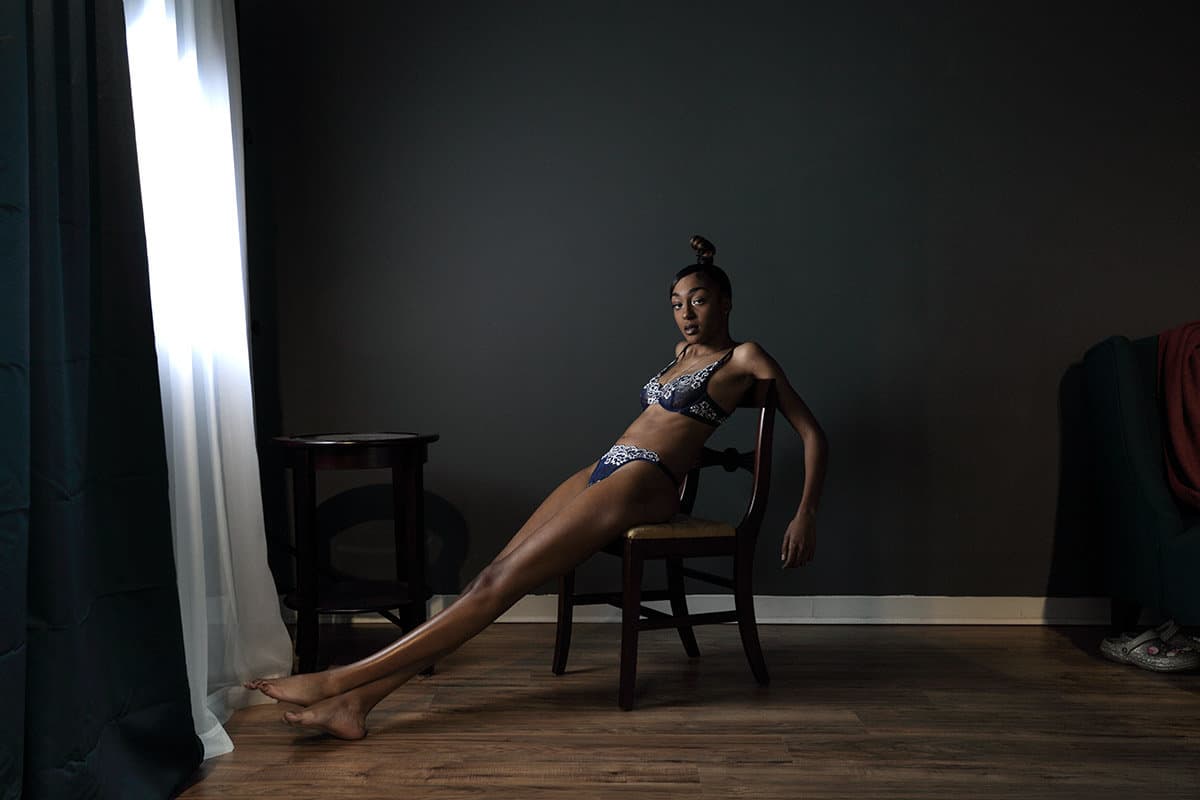 Dark and moody boudoir image with young African American woman
