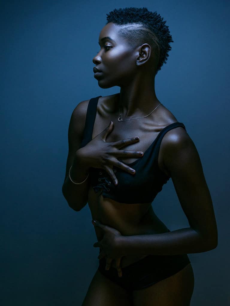 Boudoir portrait with dramatic blue lighting
